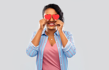 Sticker - love, valentine's day and charity concept - happy african american young woman with red hearts instead of eyes over grey background