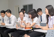 © kwanchaichaiudom - Students in uniform working with tablet in classroom