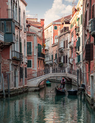 Wall Mural - A very beautiful canal in Venice with a gondola driving through the calm water