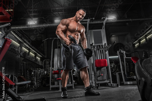 Fotomural Brutal strong athletic men pumping up muscles workout bodybuilding concept backg