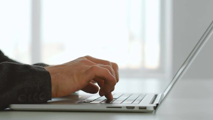 Programmer or web developer. IT technology and application design. Man hands on laptop keyboard.