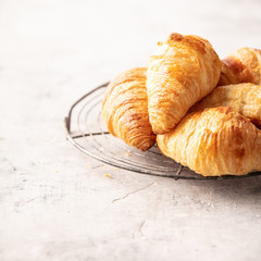 Wall Mural - Fresh croissants on light grey concrete background