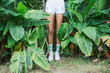 © Jovo Jovanovic/Stocksy - Legs of a young woman standing near the trees