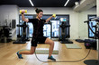 © guille Faingold/Stocksy - Sportswoman wearing EMS doing exercise with dumbbells.