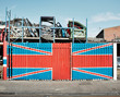 © James Ross Photography/Stocksy - The Union Jack flag on the wall of a scrap yard