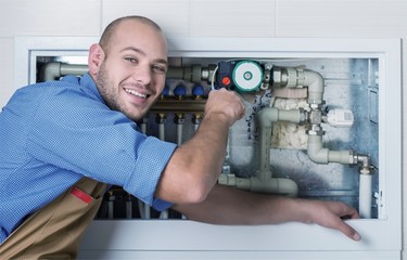 Wall Mural - Plumber hands fixing water tap on background