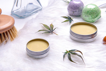 Assortment of cannabis topicals with bath bombs and marijuana salve over white