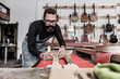 © Bisual Studio/Stocksy - Guitar luthier working in his workshop