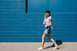 © Boris Jovanovic/Stocksy - Smiling young woman walking on street