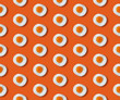 © Kaat Zoetekouw/Stocksy - Sunny side up candy with sugar sprinkled on it (salt) in a pattern on an orange background