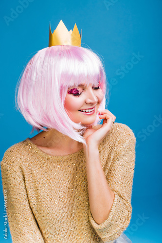 Portrait Fashionable Joyful Young Woman With Cut Pink Hair On Blue