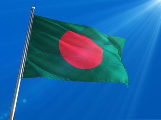 Wall Mural - Bangladesh National Flag Waving on pole against deep blue sky background. High Definition