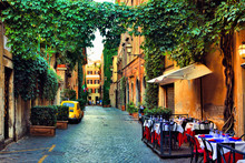 Beautiful Ancient Street In Rome Lined With Leafy Vines And Cafe Tables, Italy