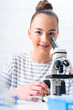 © Alex_Traksel - Teen girl student caring out experiments in chemistry class.high school students with microscopes in laboratory.