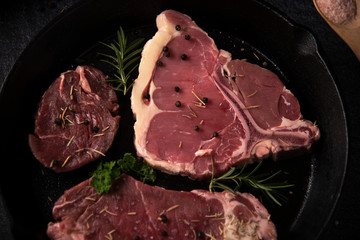 raw beef steak on wooden cutting board