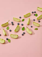 Wall Mural - apple pieces, blueberries and green basil leaves