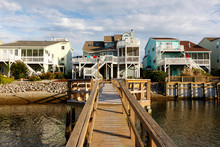Long Wooden Dock Leading To Three Luxury Vacation Rental Beach Houses On The Intercoastal Waterway, Sunset Beach, North Carolina