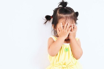 Cute asian baby girl closing her face and playing peekaboo or hide and seek with fun