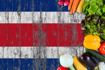 Fresh vegetables from Costa Rica on table. Cooking concept on wooden flag background.