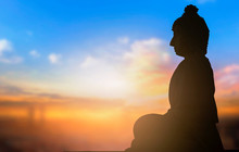 Day Of Vesak Concept: A Statue Of Buddha At Sunset Background