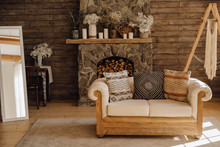 Chalet Cozy Interior Wooden Sofa And Fireplace. Rustic Home Design For Warm Indoor Space Alpine Vacation. Modern Cottage Living Room Decor With Wood Wall And Furniture. Winter Holiday Background