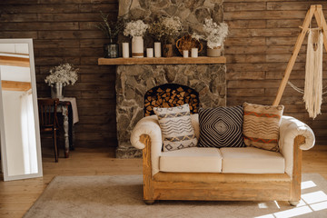 Chalet Cozy Interior Wooden Sofa and Fireplace. Rustic Home Design for Warm Indoor Space Alpine Vacation. Modern Cottage Living Room Decor with Wood Wall and Furniture. Winter Holiday Background