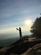 © GK_musaico - Silhouette woman taking photo with smartphone at mountain peak
