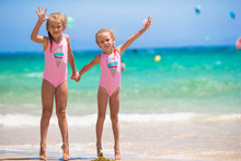 Adorable Little Girls Having Fun During Beach Vacation