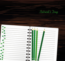 Notebook with template hand-drawn Green festive bunting with clover and pencil. Irish holiday - Happy St. Patrick's Day with a garland of three-leaf. Greeting card on holiday. Vector on wooden backgro