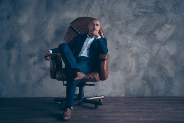 Wall Mural - Portrait serious stunning agent economist sit furniture manager representative manager brown dream dreamy touch chin short hair bald cross legs satisfied modern jacket isolated dark background
