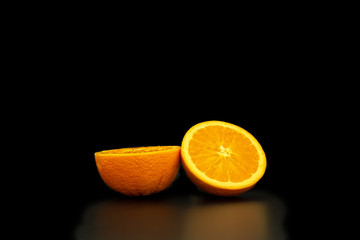 A fresh and healthy the orange on a black background.