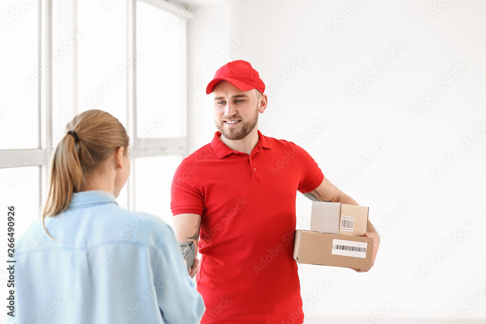 Woman paying courier for delivery of parcels