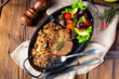 Pork steak with mushrooms and buckwheat groats and mango salad