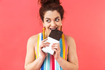 Sticker - Smiling pretty redhead woman wearing in dress eating chocolate