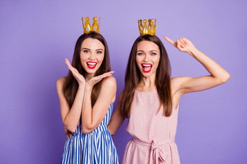 Sticker - Close up portrait two people beautiful she her models chic ladies hands arms palms air power status gold crowns head yelling wear summer colorful dresses isolated purple violet bright background