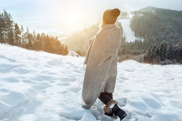 Happy woman traveler on the snowy of mountain look on the nice w