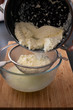 Separating freshly made ricotta cheese from the whey