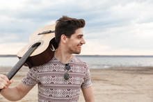 Cheerful Young Man Carrying Guitar