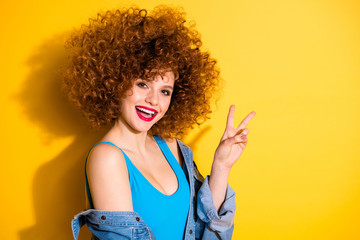 Close-up portrait of her she nice confident lovely sweet feminine girlish winsome charming attractive cheerful glamorous girl showing v-sign isolated over bright vivid shine yellow background