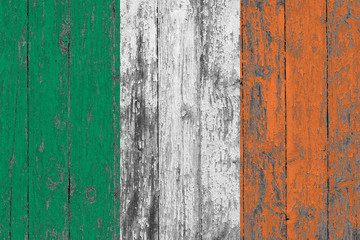 Wall Mural - Flag of Ireland painted on worn out wooden texture background.