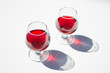 © Natalia - Glasses with red wine on a white background
