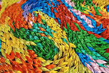 A "sea" Of Colorful Origami Paper Boats Creating A Swirling Pattern