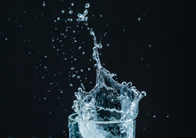 Water Splash In Glass With Black Background
