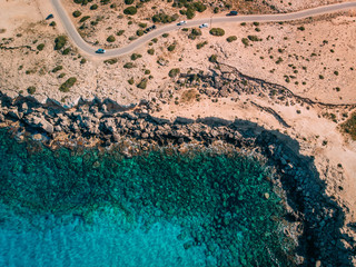 Sticker - Aerial overhead Rocky seashore with crystal clear blue water near Cape Cavo Greco, Cyprus