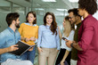 © BGStock72 - Multiethnic group of young people standing in the modern office and brainstorming