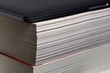 © Colobus - Laptop computer stacked upon thick soft cover book