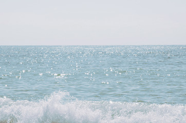 Canvas Print - the waves of the sea. The glare of the sun in the water. The blue background of the sea