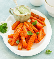 Canvas Print - Baked spiced pumpkin slices with avocado sauce. shooting from above.