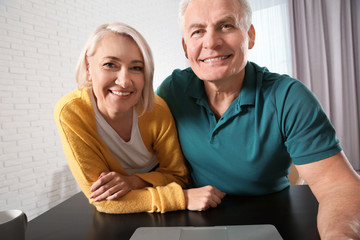 Canvas Print - Mature couple using video chat at home, view from web camera