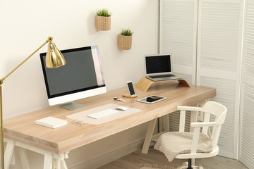 Canvas Print - Stylish workplace interior with modern computer on table. Mockup for design